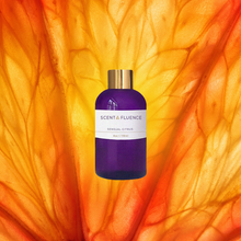 Load image into Gallery viewer, Scentfluence purple bottle with gold cap on an close up citrus background
