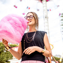 Load image into Gallery viewer, Woman eating cotton candy at amusement park
