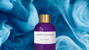 Purple bottle with gold cap on a blue and white smoke background, featuring ScentFluence scent oli