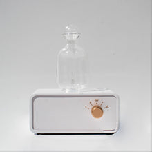 Load image into Gallery viewer, Room scent diffuser. Glass urn atop white base with gold knob