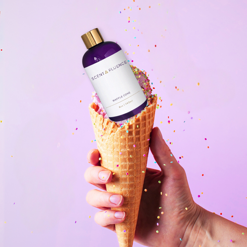 Hand holding ice cream cone with Waffle Cone scent oil as smelled at Museum of Ice cream bottle and sprinkles falling